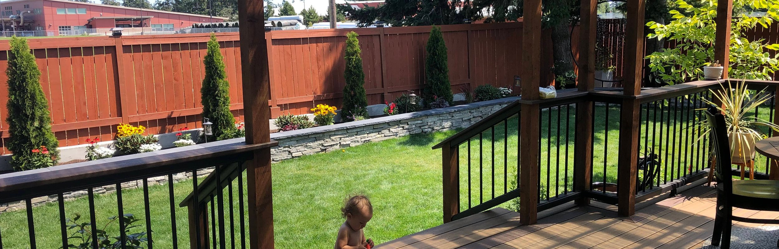 Wooden deck, pergola, and landscaped backyard in Oak Harbor