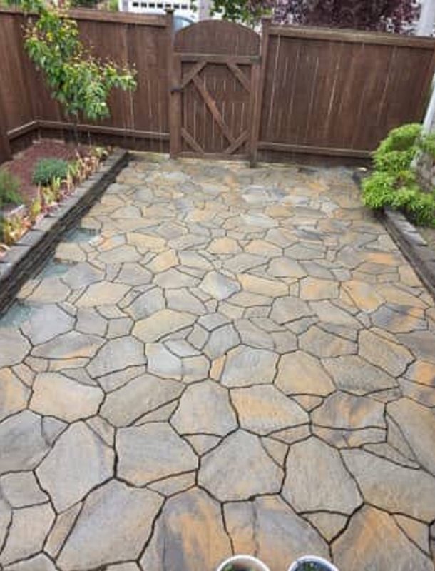 Flagstone patio with stone garden borders in an Oak Harbor backyard