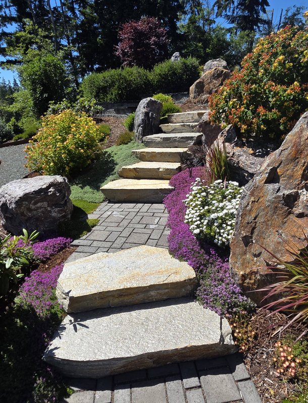 Stone path and steps through a planted hillside garden on Whidbey Island
