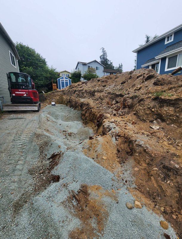 Hillside excavation and site prep for a retaining wall in Oak Harbor