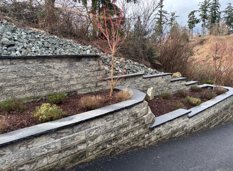Tiered block retaining wall with planting beds in Oak Harbor